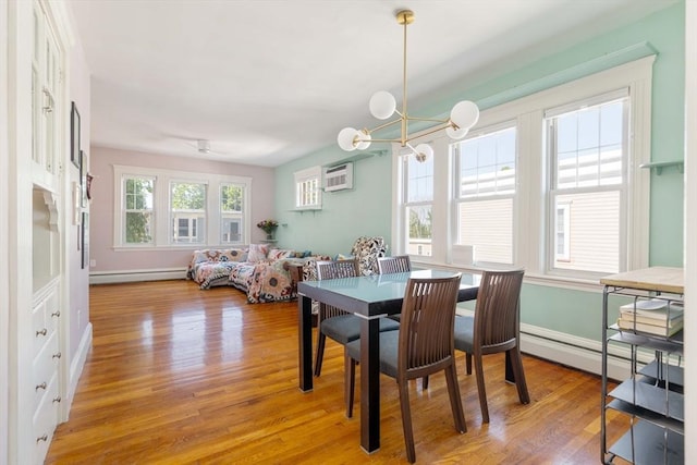 42 Lourdes Ave Unit 3, Boston, MA 02130 - dining room featuring a baseboard radiator, light wood finished floors, a wall unit AC, and a chandelier