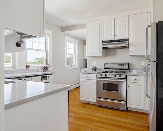 42 Lourdes Ave Unit 3, Boston, MA 02130 - kitchen featuring stainless steel range with gas cooktop, under cabinet range hood, freestanding refrigerator, white cabinetry, and light countertops