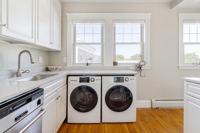 42 Lourdes Ave Unit 3, Boston, MA 02130 - laundry area featuring a baseboard heating unit, independent washer and dryer, light wood-type flooring, and cabinet space