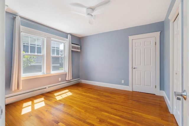42 Lourdes Ave Unit 3, Boston, MA 02130 - empty room with baseboard heating, wood finished floors, a ceiling fan, and a wall unit AC