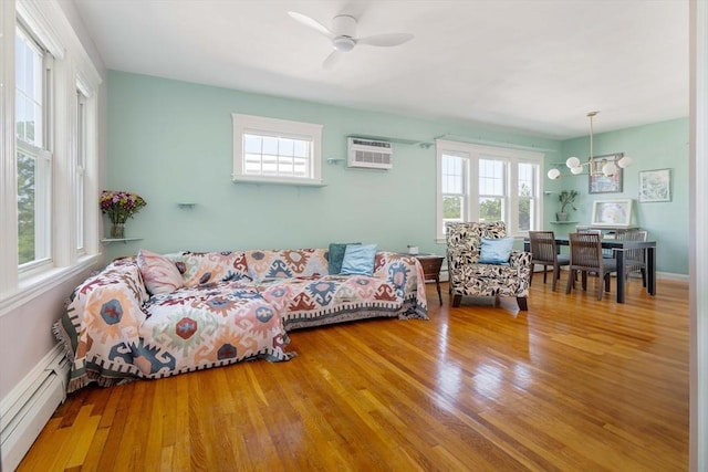 42 Lourdes Ave Unit 3, Boston, MA 02130 - living room with baseboard heating, plenty of natural light, wood finished floors, and a chandelier