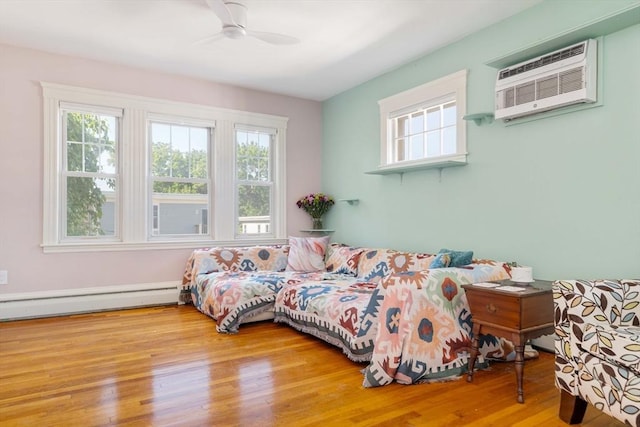 42 Lourdes Ave Unit 3, Boston, MA 02130 - bedroom featuring a baseboard radiator, multiple windows, an AC wall unit, and wood finished floors