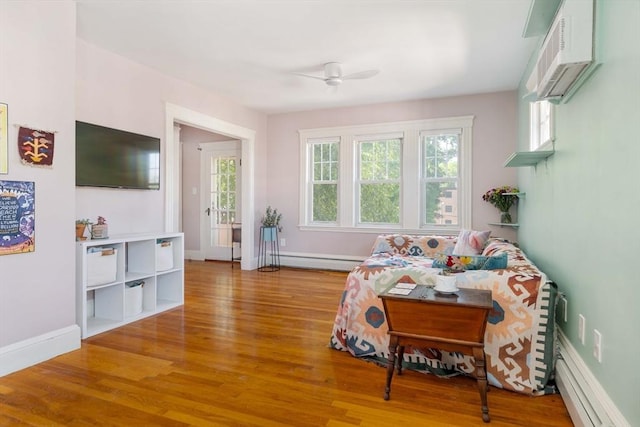 42 Lourdes Ave Unit 3, Boston, MA 02130 - living area with a baseboard radiator, ceiling fan, healthy amount of natural light, and wood finished floors
