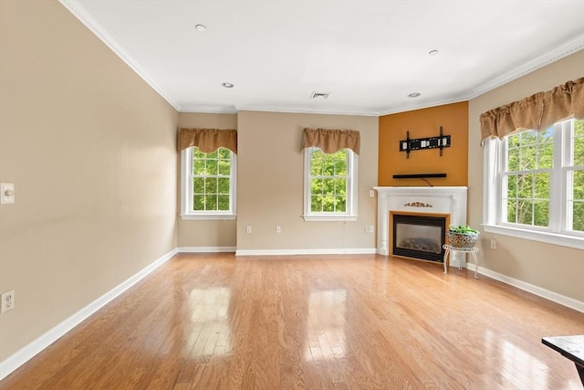 190 Chickering Rd Unit 201D, North Andover, MA 01845 - unfurnished living room featuring light wood-style flooring, a glass covered fireplace, ornamental molding, and baseboards