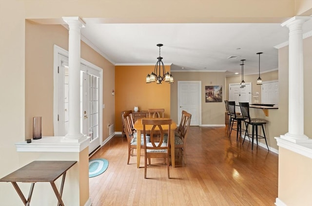 190 Chickering Rd Unit 201D, North Andover, MA 01845 - dining space featuring decorative columns, light wood-style floors, ornamental molding, and baseboards