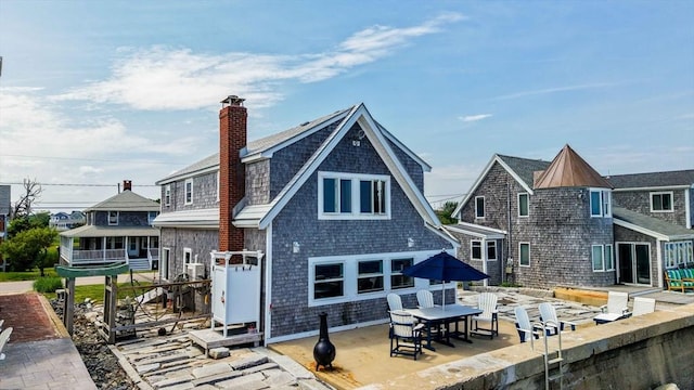 36 Ocean St, Marshfield, MA 02050 - rear view of house with a patio area and a chimney