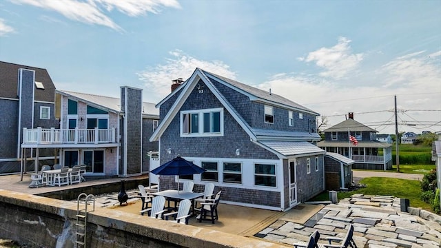 36 Ocean St, Marshfield, MA 02050 - rear view of house with a patio and outdoor dining space