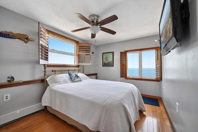 36 Ocean St, Marshfield, MA 02050 - bedroom featuring a baseboard radiator, wood finished floors, and ceiling fan