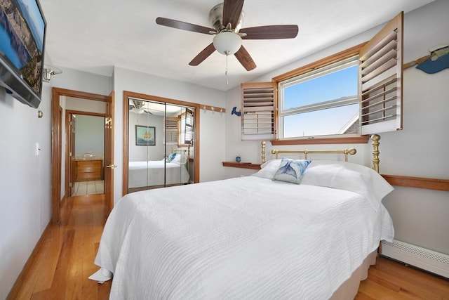 36 Ocean St, Marshfield, MA 02050 - bedroom featuring a baseboard heating unit, wood finished floors, a closet, and ceiling fan