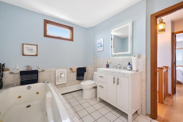 36 Ocean St, Marshfield, MA 02050 - full bath featuring a jetted tub, tile walls, tile patterned floors, vanity, and a wainscoted wall