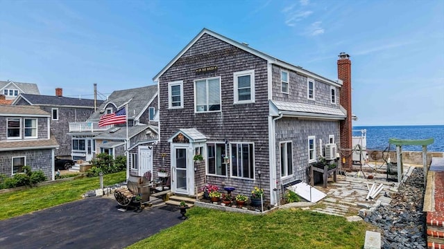 36 Ocean St, Marshfield, MA 02050 - shingle-style home with a chimney, a water view, a front yard, and a patio area