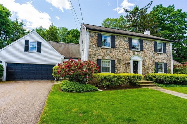 23 Ascenta Ter, Newton, MA 02465 - colonial inspired home with stone siding, a chimney, a front lawn, driveway, and a garage