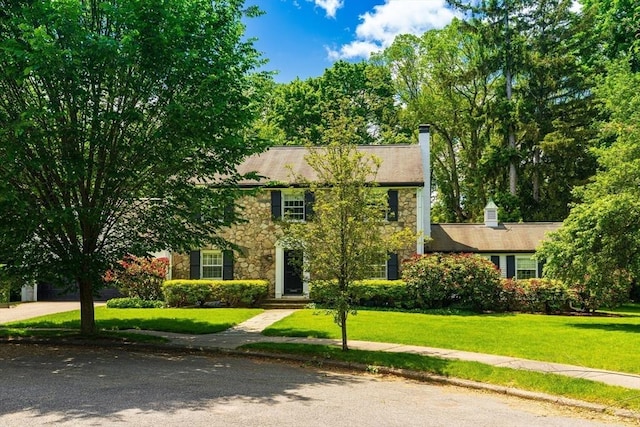 23 Ascenta Ter, Newton, MA 02465 - colonial inspired home with stone siding, a front lawn, and a chimney