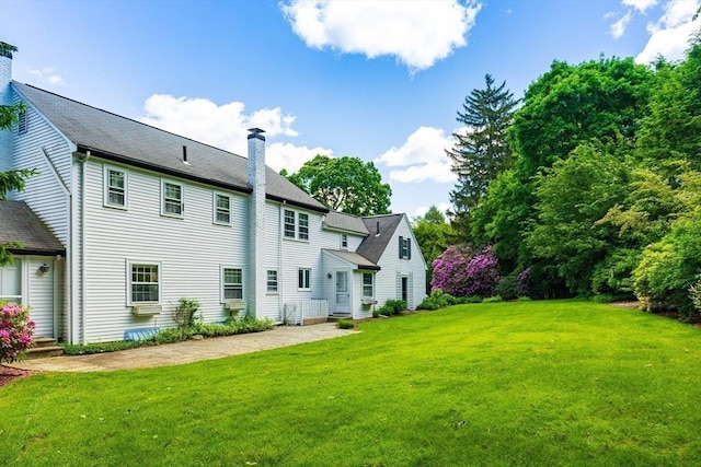 23 Ascenta Ter, Newton, MA 02465 - back of house featuring a chimney and a yard