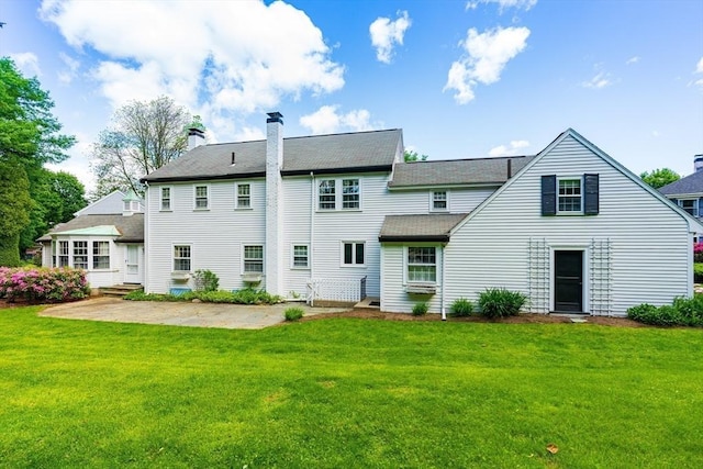 23 Ascenta Ter, Newton, MA 02465 - back of property with a yard, a patio area, and a chimney