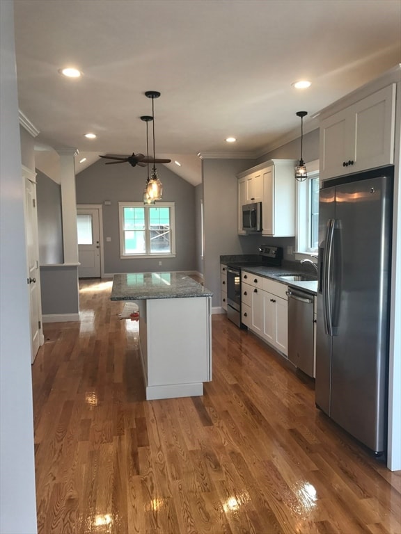 kitchen with appliances with stainless steel finishes, dark wood-type flooring, and white cabinets