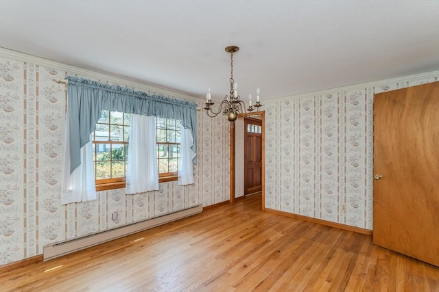 unfurnished dining area with an inviting chandelier, wood finished floors, baseboards, baseboard heating, and wallpapered walls