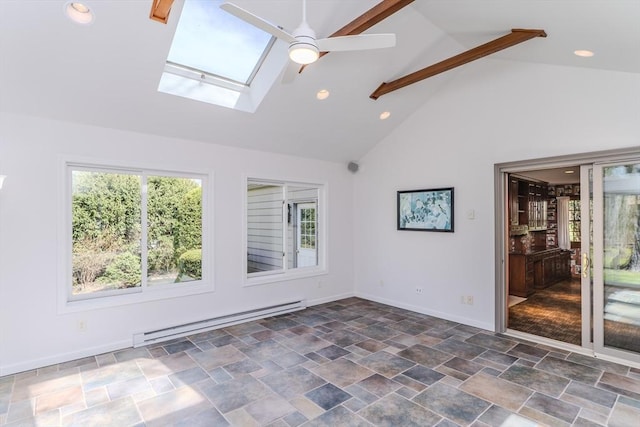 spare room featuring ceiling fan, baseboard heating, high vaulted ceiling, stone finish flooring, and a skylight