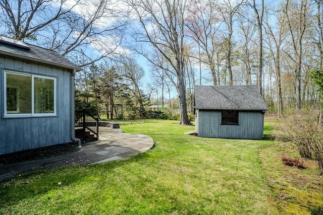 view of yard featuring an outbuilding and a shed