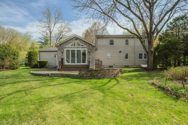 back of property featuring entry steps, a yard, and crawl space
