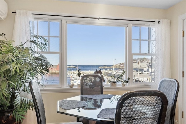 dining room featuring a water view and a wall mounted air conditioner