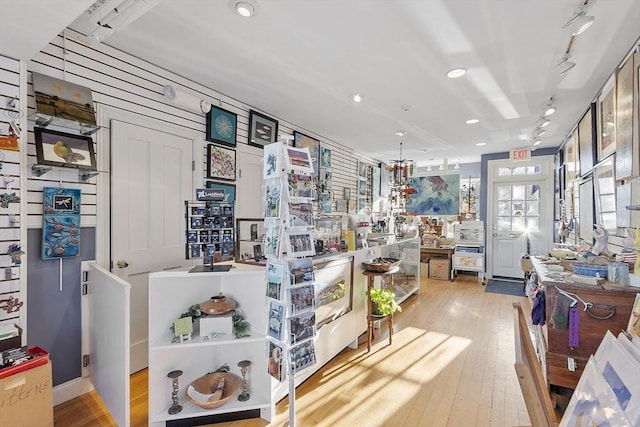 interior space with light wood finished floors, recessed lighting, and rail lighting