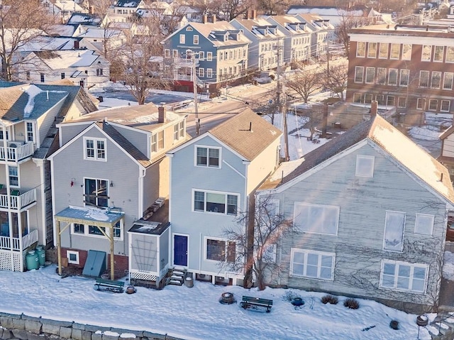 snowy aerial view featuring a residential view