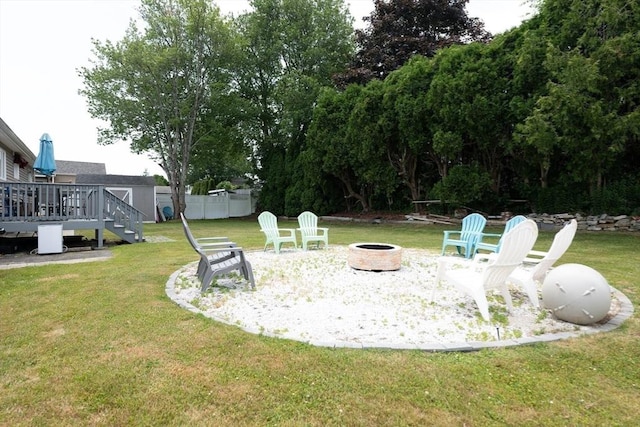 11 Ann Ave, Dartmouth, MA 02747 - view of green lawn featuring a fire pit and a wooden deck