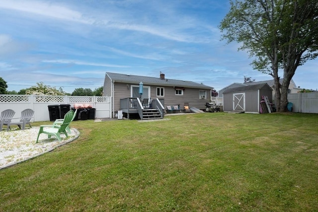 11 Ann Ave, Dartmouth, MA 02747 - back of property with a deck, a fenced backyard, a storage shed, and a chimney