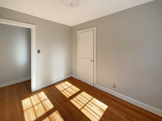 unfurnished bedroom featuring a closet and hardwood / wood-style floors