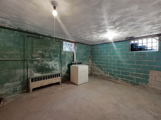 basement with washer / clothes dryer and radiator