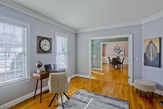 office space with ornamental molding, light wood finished floors, visible vents, and baseboards