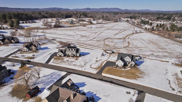 snowy aerial view featuring a mountain view