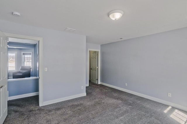 unfurnished bedroom featuring carpet flooring and baseboards