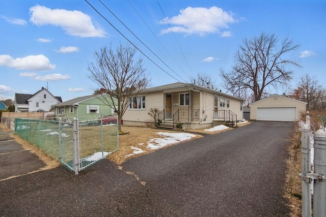 view of front of house featuring a garage, a gate, fence, and an outdoor structure