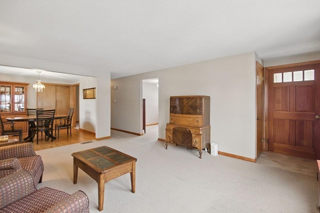 carpeted living area featuring visible vents and baseboards