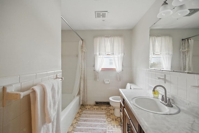 full bathroom featuring visible vents, toilet, tile walls, and vanity