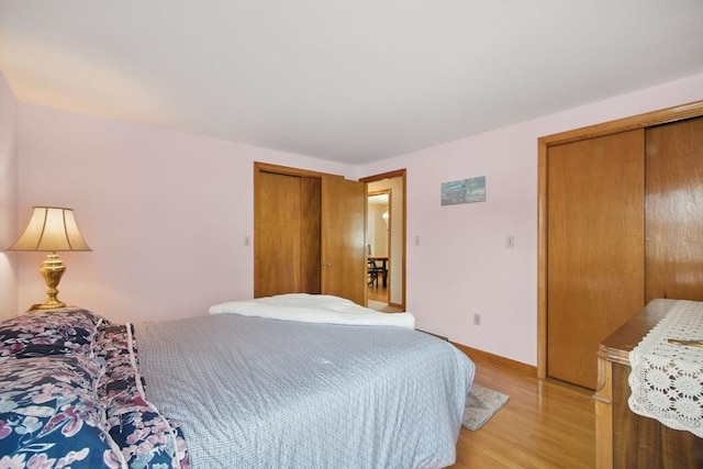 bedroom with light wood-type flooring and baseboards