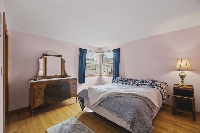 bedroom with wood finished floors and baseboards