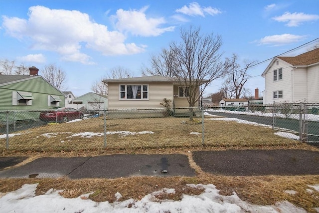 view of front of home with fence private yard and a detached garage