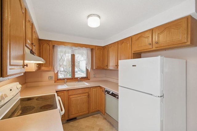 kitchen with under cabinet range hood, white appliances, a sink, visible vents, and light countertops