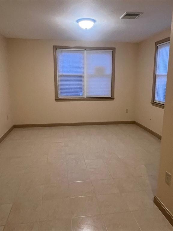 empty room with visible vents and baseboards