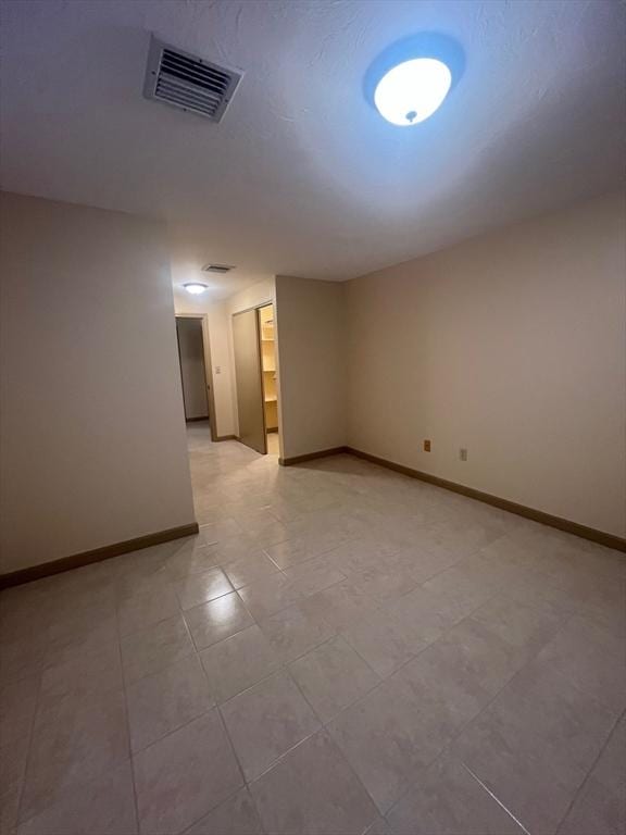 empty room with baseboards and visible vents