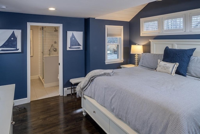 bedroom featuring vaulted ceiling, a baseboard heating unit, dark hardwood / wood-style flooring, and ensuite bath