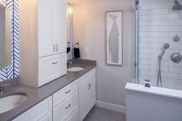 bathroom with vanity, tile patterned flooring, and tiled shower