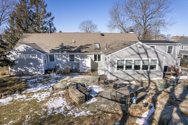 snow covered house featuring an outbuilding