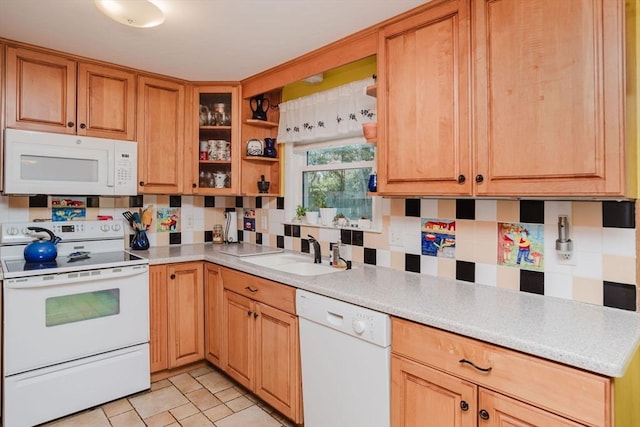 kitchen featuring sink, white appliances, and decorative backsplash