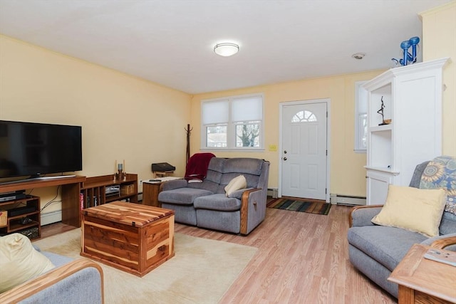 living room featuring a baseboard heating unit and light hardwood / wood-style floors