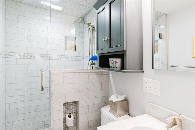 bathroom with walk in shower, vanity, and toilet