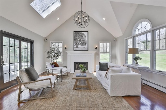 living area with high vaulted ceiling, plenty of natural light, and wood-type flooring